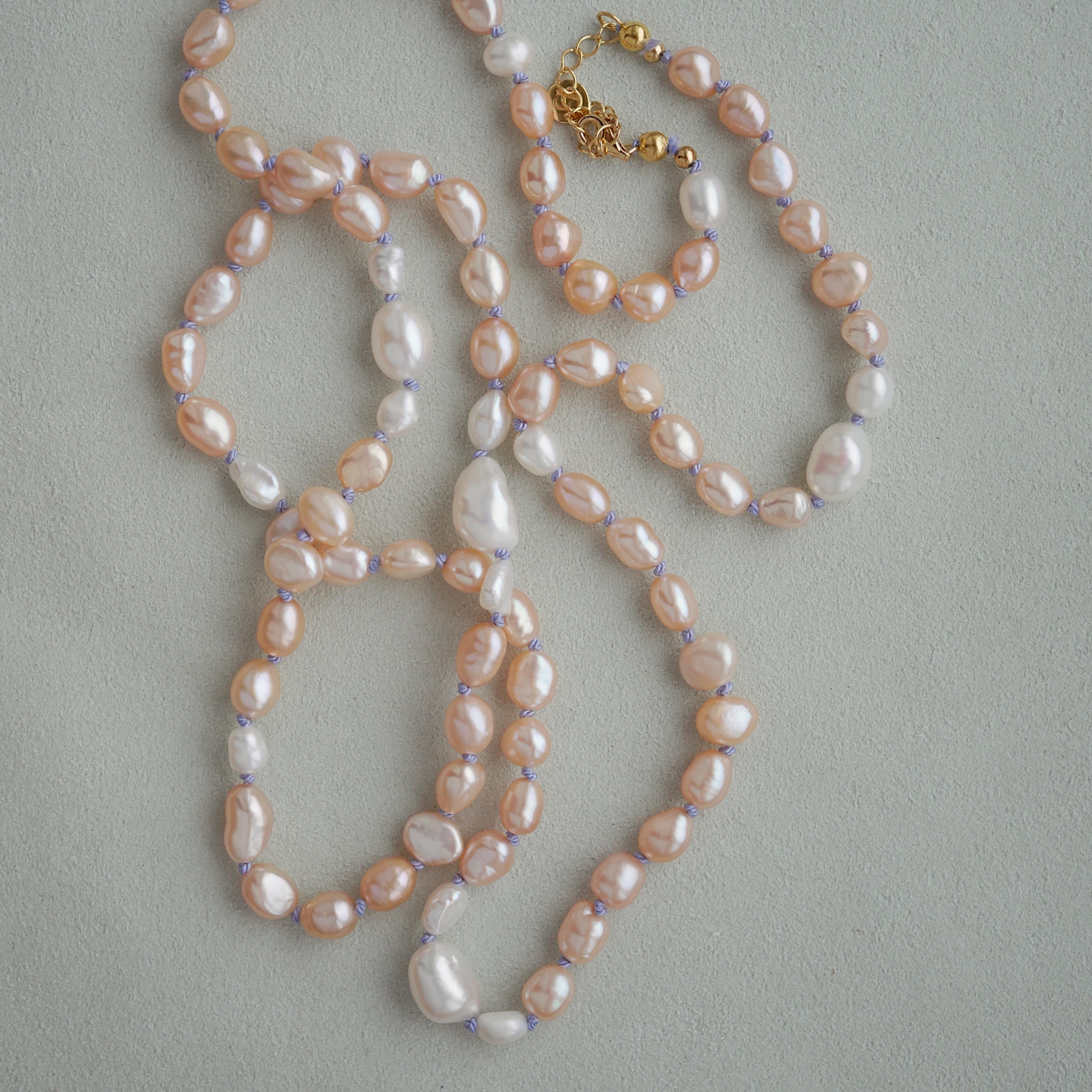 long peach and white pearl necklace