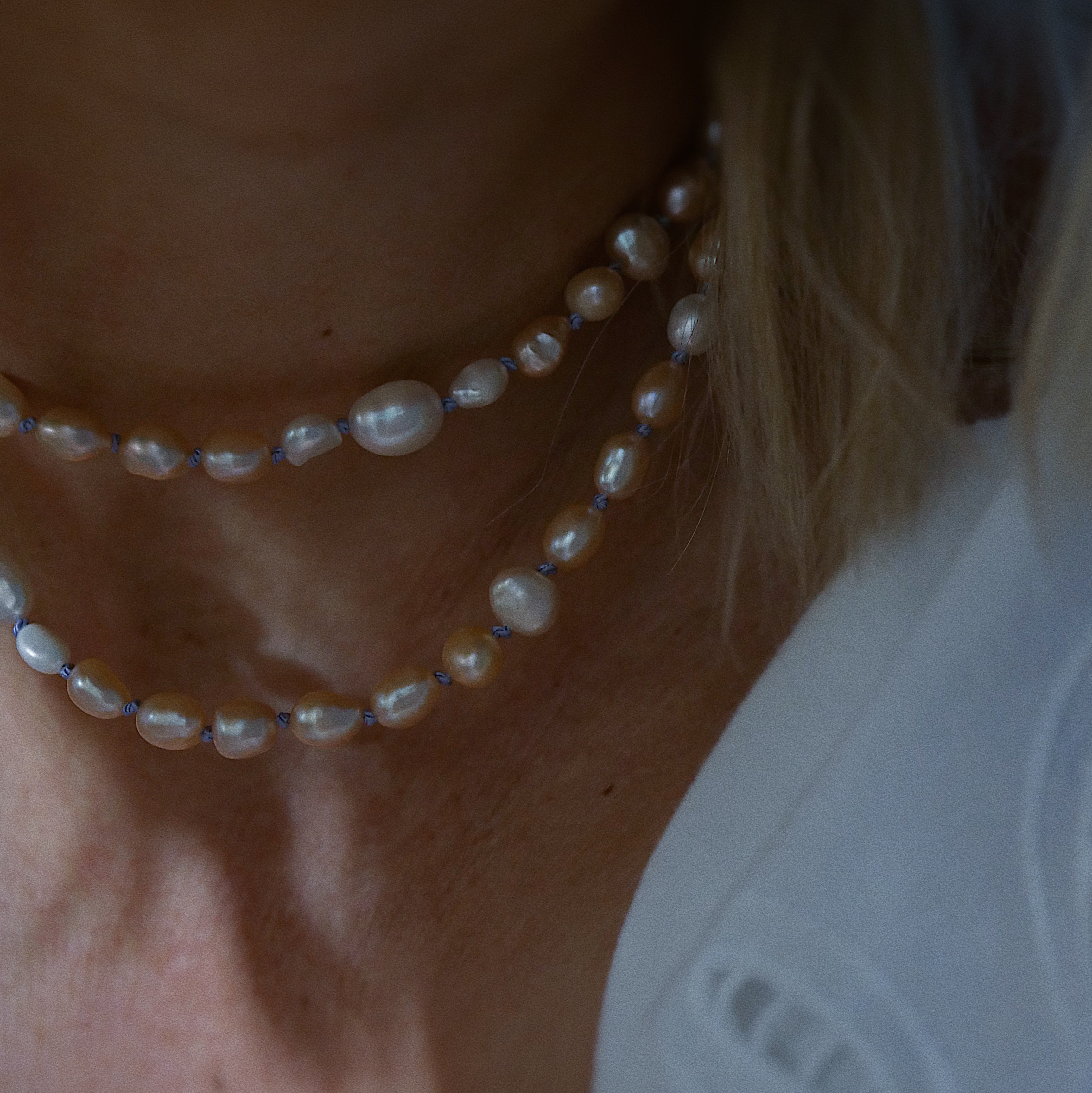 Long peach and white pearl necklace