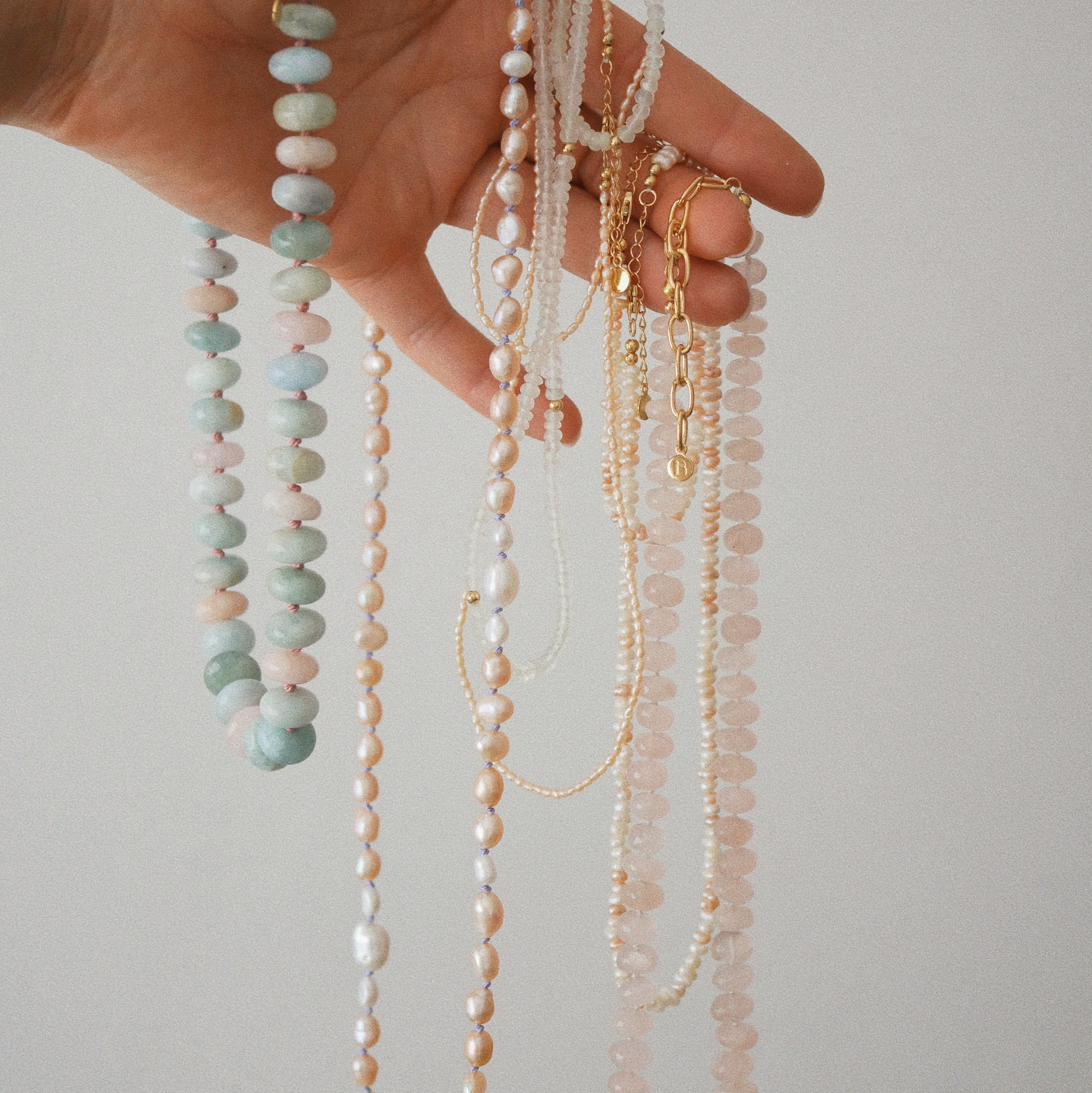 Long peach and white pearl  and gemstone necklaces